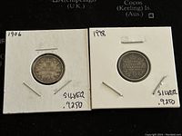 Front and back view of two Canadian 10 cents coins from 1906 and 1998, showing the silver content and dates.