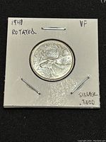 Reverse side of the 1940 Canadian silver 25 cents coin showing the caribou design with date and silver content noted on the holder.