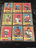 Photo of nine hockey trading cards from the 1972-3 O-Pee-Chee series showing front sides with player images and team logos.