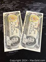 Pair of consecutive 1973 Canadian one dollar banknotes featuring Queen Elizabeth II, serials B01737388 and B01737389