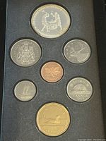 Photo showing front side faces of all coins included in the 1988 Canadian Silver Proof Double Dollar Set, displaying various denominations with detailed designs and Queen Elizabeth II portraits.