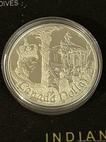 Reverse side showing crowned Queen Elizabeth II seated on an ornate throne, with 'Canada Dollar' inscription.