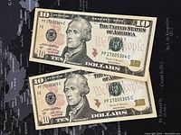 Front side of the two consecutive $10 US banknotes showing Alexander Hamilton portrait and serial numbers PF17205304C and PF17205305C.