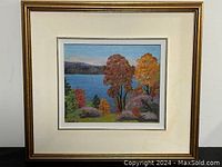Full view of framed print showing autumn landscape with lake and colorful trees in gold frame.