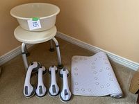 Viewing the full set showing adjustable shower stool, plastic wash basin placed on top of stool seat, rolled shower mat beside, and four suction hand bars in front