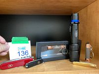 Full lot including two Swiss Army knives, mini gold cutter, two flashlights and pen in box.