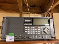 Front left perspective showing speaker grill, signal strength meter and LCD display