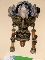 Front view of international mask showing facial detail and stone embellishments