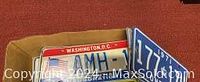 Box with a Washington D.C. license plate and partial view of another plate beneath it.