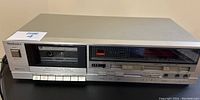 Front overview of Technics cassette deck with cassette inserted and power off.
