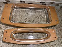 Two Giannini brand Mid-Century Modern style serving trays with wood frames and inset glass, displayed on countertop.