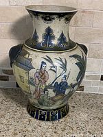 Front view of vintage hand-painted Chinese ceramic vase with figurative scene and wide neck.