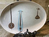 View of the oval platter showing the three stylized lute music instrument designs