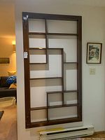 Full front view of wall-mounted shelf showing overall design and dimensions