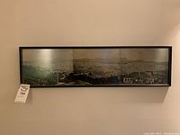 Wide shot of the entire framed panoramic black-and-white Hong Kong harbor scene featuring the hotel building.