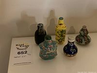 Five bottles arranged in a row showing overall lot