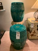 Two stools stacked atop each other and one on floor showing overall form and glaze finish