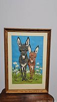 Front view of the 'Togetherness' donkey art print in oak frame showing full artwork and frame condition
