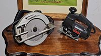 Photo showing both the Black & Decker circular saw and the Skil jigsaw on a wooden surface.