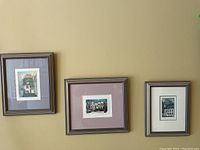 Showcases all three framed numbered art prints hanging on wall in a row.