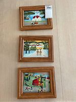 Three 5x7 framed prints copying Maud Lewis paintings, all signed MH, shown on light wood background
