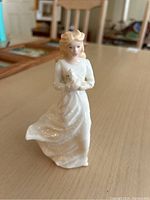 Front view of Royal Doulton Loving You figurine holding a cat.