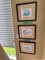 Three framed prints on wall from a distance showing size and grouping