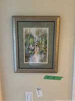 Photo of framed watercolour on wall showing a couple walking on a tree-lined path with a building dome in background, with a gray wooden frame and mat board, size labeled 15x19 inches.