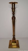 Full view of brass candlestick showing overall shape, height, and finish.
