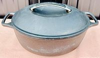 Image showing KitchenAid cast iron casserole/braizer with lid, closed view from the top showing handles and lid with KitchenAid engraved handle.