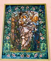 Clear photo showing full view of the miniature glass window and its intricate reproduction of the Madonna of the Flowers stained glass artwork.