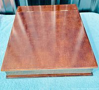 Closed top view of the dark wood writing box showing the slant top design and wood grain finish.