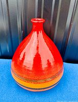Front view of the vase showing the full teardrop shape and glossy red upper glaze.