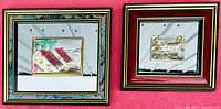Pair of two framed Creazoni 3D silver art pieces shown side by side against a red background, each with mirror borders and marble patterned outer frames