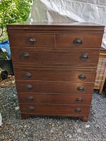 Front view of mahogany chest of drawers showing full height and drawer configuration