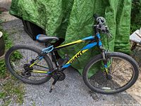 Side view of Giant mountain bike showing frame, tires, saddle and handlebars. Bike is blue, black and yellow color with branded markings and gear system.