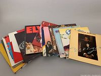Photo showing a spread of 16 assorted vintage vinyl records in various album covers, including artists like George Benson, Captain and Tenille, and Mireille Mathieu.