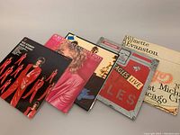 Five vinyl albums displayed showing front covers: two Rod Stewart, two Eagles, one Chicago.