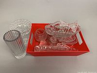Full lot on red tray showing various crystal dishes, small bowls, and holders