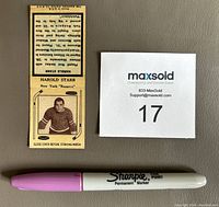 Front side of the Harold Starr matchbook cover showing NHL player portrait and descriptive text, with size reference items visible.