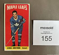 Front of 1964-65 Topps Tall Boy hockey card showing George Armstrong in Toronto Maple Leafs uniform with a red background.