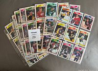 Photo showing multiple binder pages with hockey cards spread out, displaying a variety of player cards in good condition.