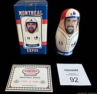 Photo showing original box with image of Larry Parrish in Montreal Expos uniform, the largest nesting doll, certificate of authenticity numbered 1506 of 5000, and lot tag.