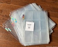 Stack of clear Ultra Pro Platinum 9-card pages with maxsold lot number visible, showing the overall quantity and condition.