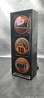 Traffic light styled decorative piece with Harley Davidson themed wording and logos, photographed from the front.