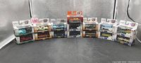 Photo displaying 15 M2 Machines diecast car boxes in 1:64 scale, all sealed in original packaging, various colors and models arranged in a row