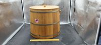 Wooden fermenting barrel with metal bands and removable lid, ruler included for scale