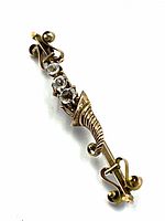 Front view showing full length of brooch, three diamonds and scroll motifs