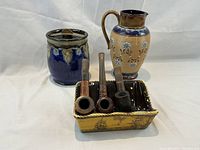 Photo of the entire set showing the humidor, pipe stand with pipes, and pitcher together on a white background.