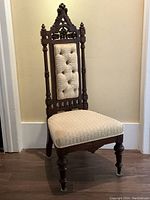 Front angle view showing overall chair form, carved frame and upholstery